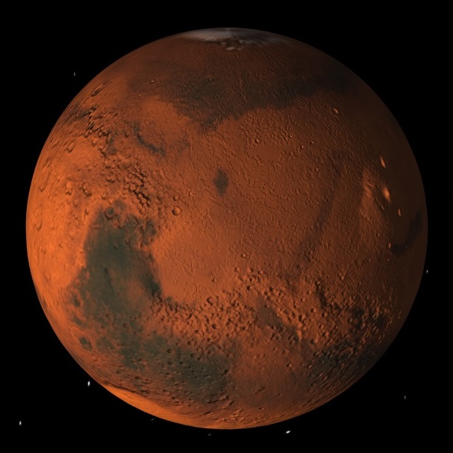 Different bits of Mars are different colours. On the far right, Martian mountains can be seen catching the sun, including Olympus Mons, which at 24,000m tall is 3 times higher than Everest.